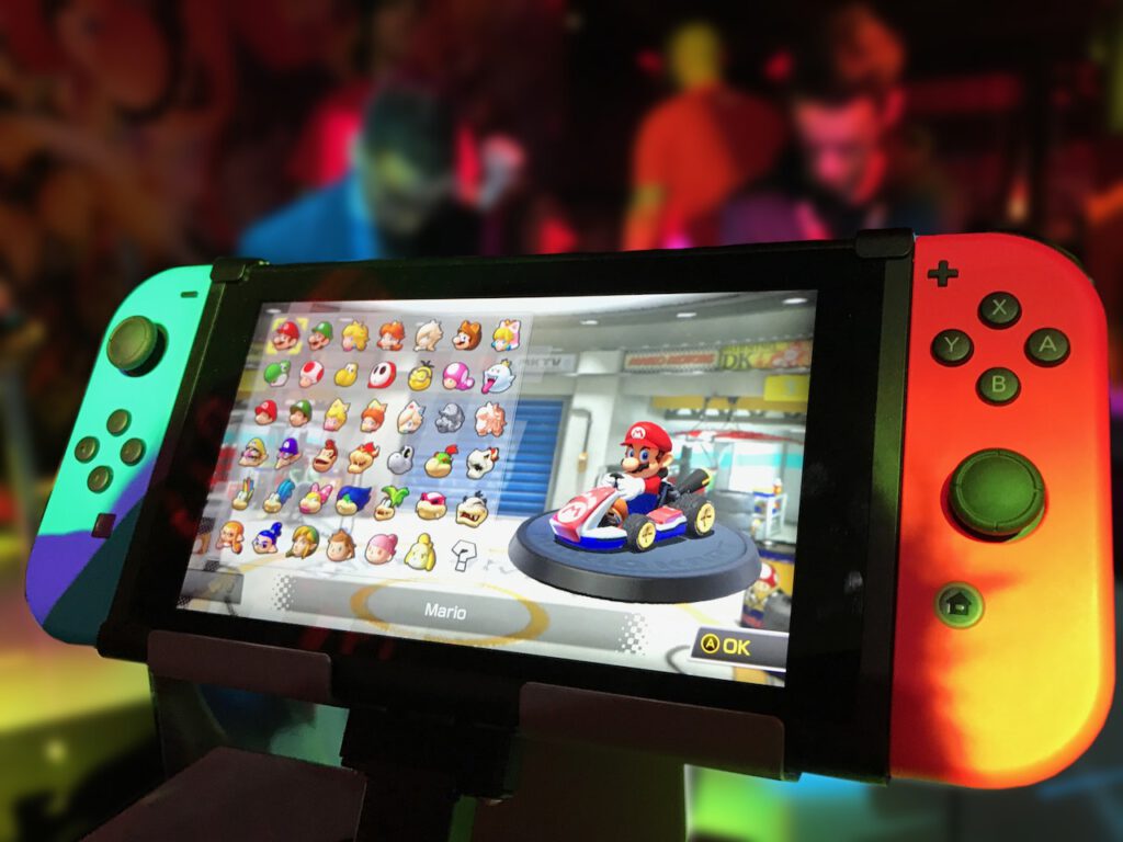 Console of Nintendo Switch is bing used by a kid who is playing mario bros game